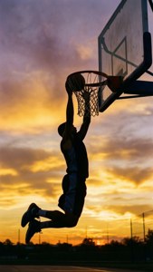 A poetic silhouette of an NBA-style dunk at sunset, evoking dreams and ambition.