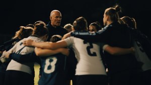 Field hockey team in a huddle before the game.