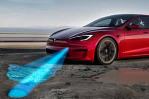 Red Tesla car speeding with blue energy trail on wet road. — Tesla Background