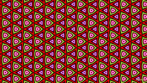 Kräftiges geometrisches Muster aus roten, pinken und grünen Dreiecken in einem sich wiederholenden Design. — Abstract Triangle Wallpaper