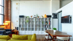 Cozy modern loft with green sofa brick wall and vinyl record collection.