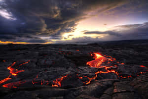 Lava flows glow red across cooled volcanic rock at twilight. — Magma Picture