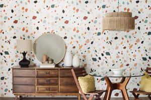 Terrazzo wallpapered dining room with wooden furniture and woven pendant light.