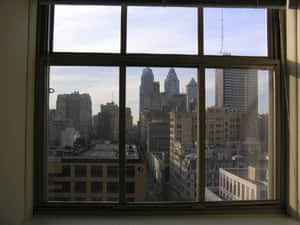 Cityscape seen through a window with multiple panes and wooden frames. — Sunshine Background