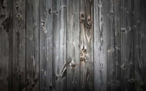 Close-up of weathered gray wooden planks with visible grain and knots. — Grey Wallpaper