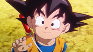Young anime boy Goku with spiky black hair and red sword smiling brightly.